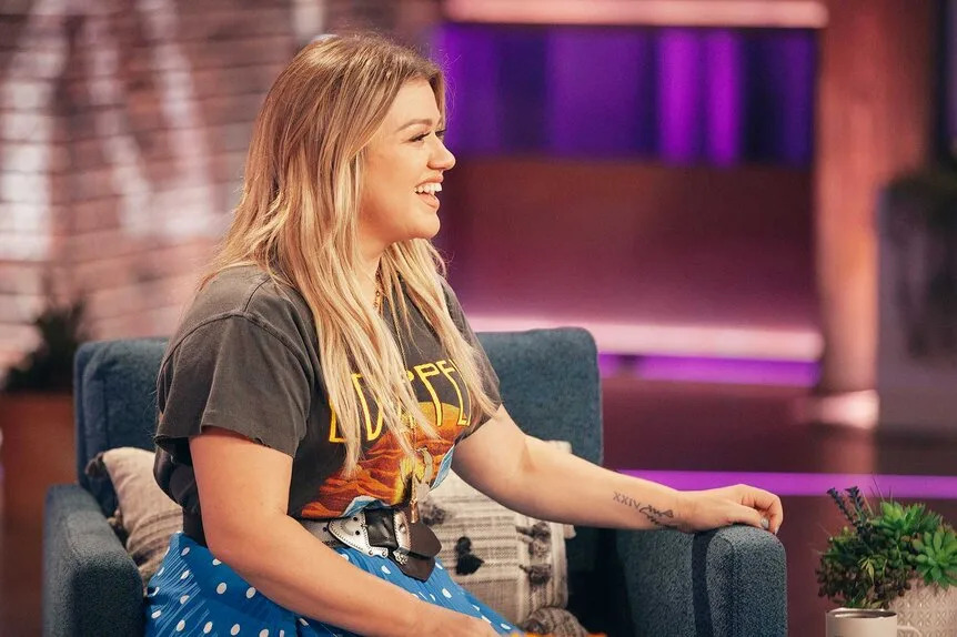 Kelly Clarkson wrist cross tattoo close-up