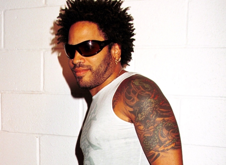Lenny Kravitz showing the Japanese-style dragon tattoo across his arm and chest