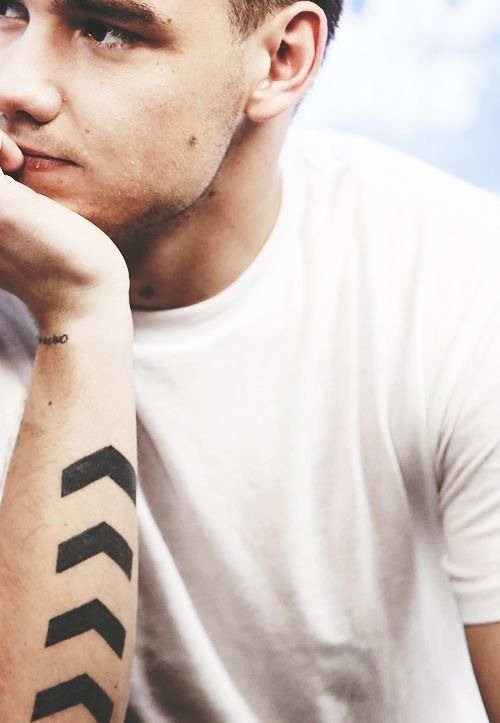 Liam Payne showing script lettering on his forearm
