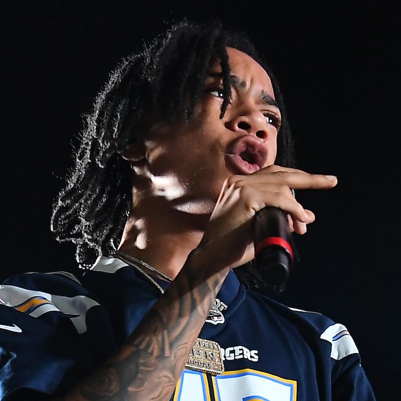 YBN Nahmir performing with visible forearm tattoos