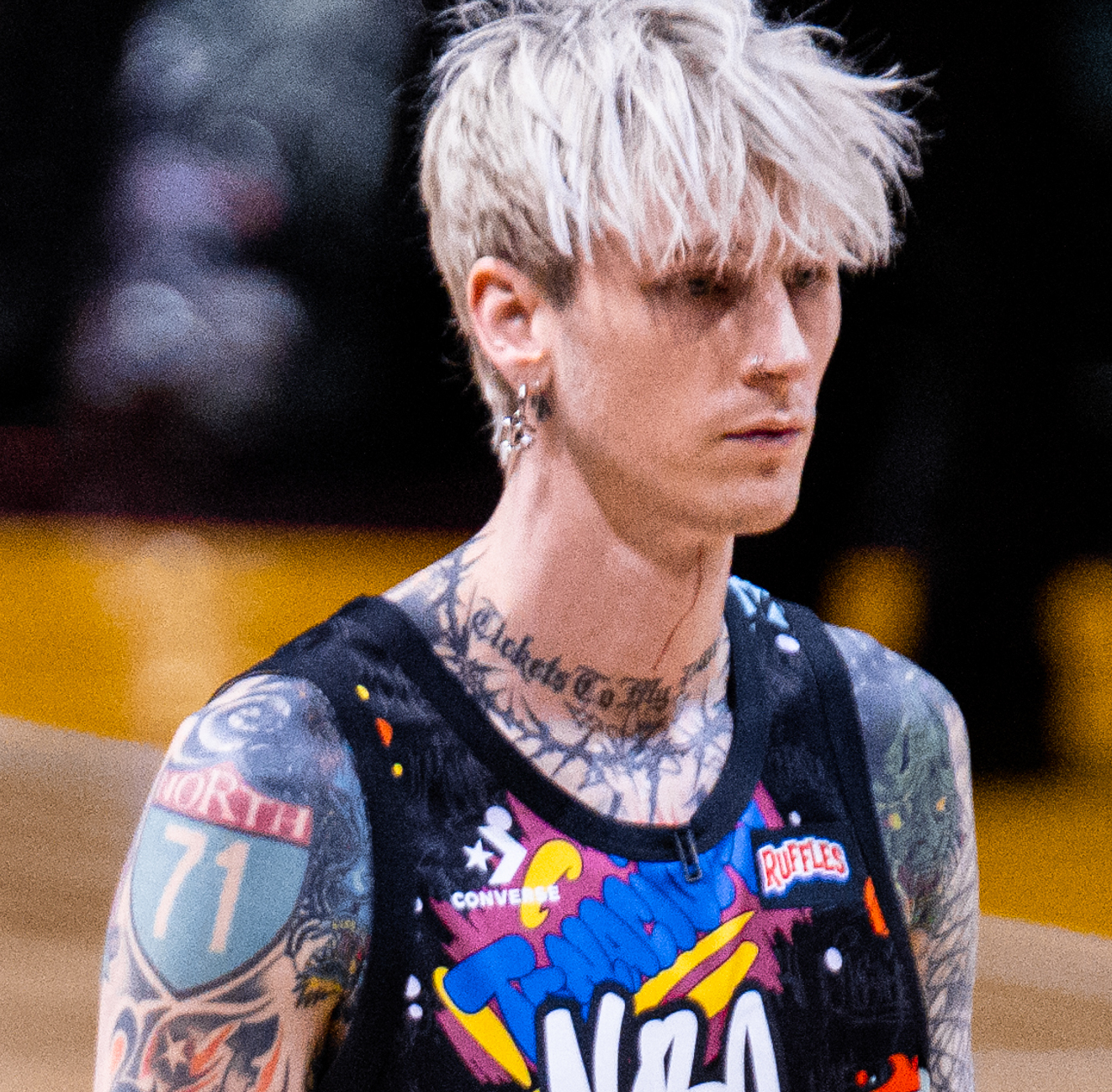 Machine Gun Kelly in 2022 with the lettering and layered designs on his neck visible
