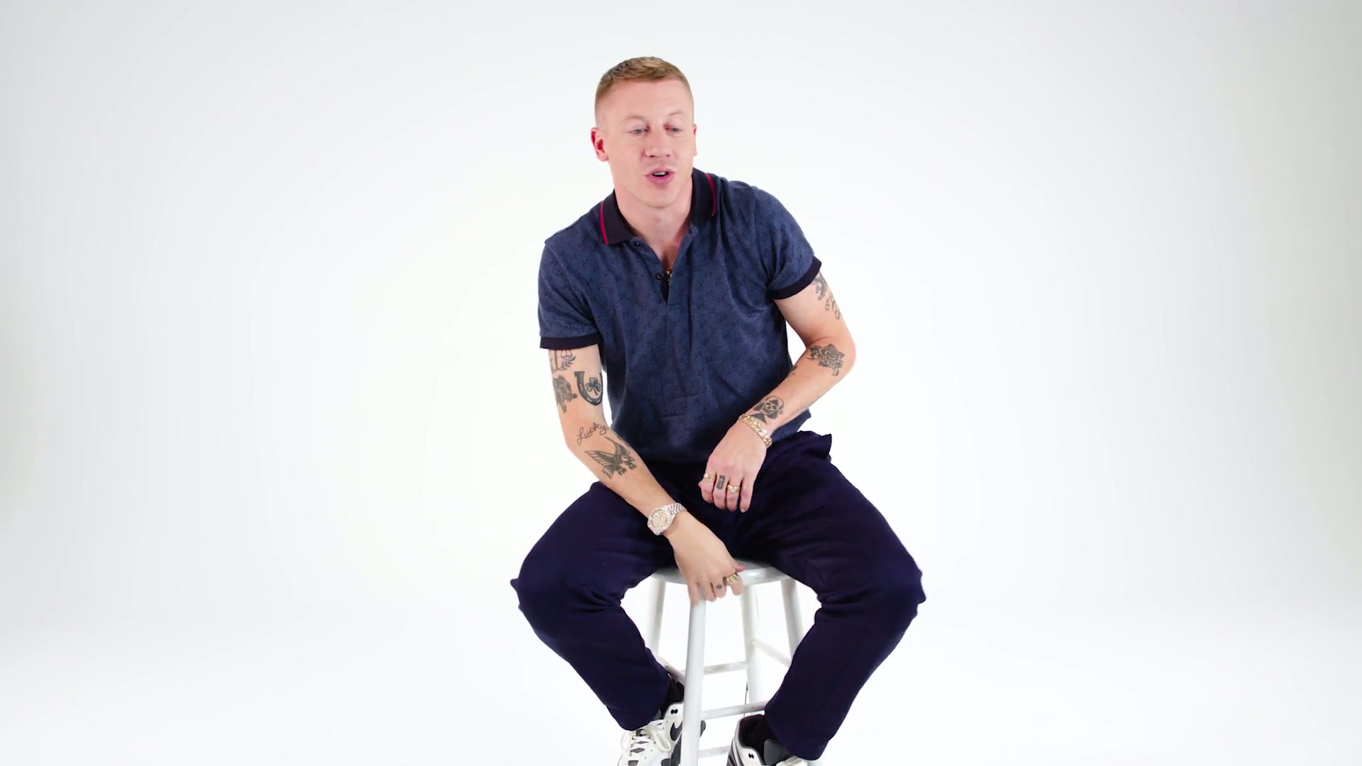 Macklemore forearm tattoos shown in a GQ Tattoo Tour close-up