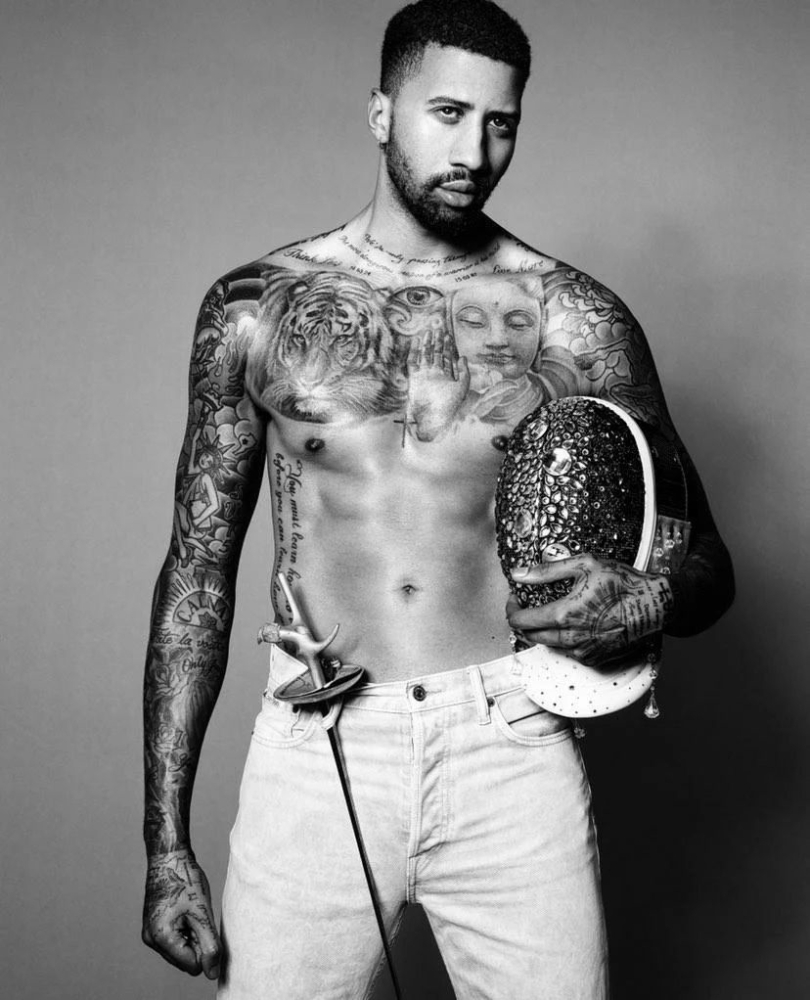 Miles Chamley-Watson showing his tattooed torso and arms