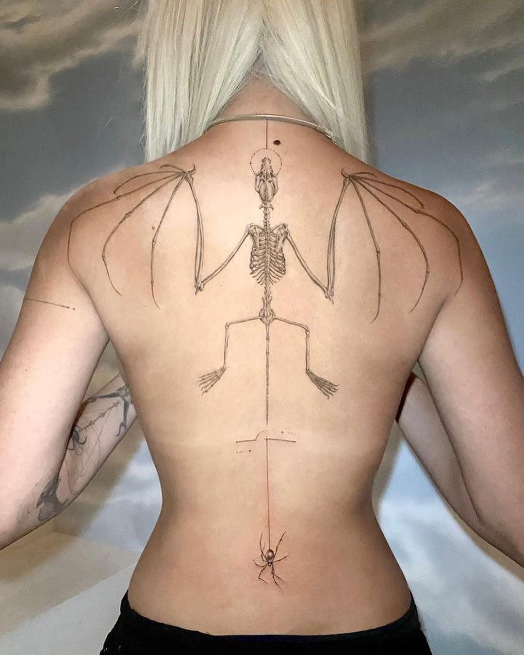 Doja Cat tattoos: clear view of Doja Cat’s bat, lower-back spider and surrounding fine-line work