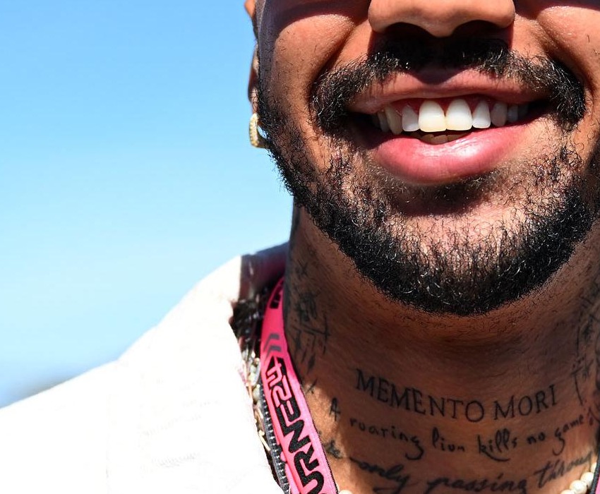 Miles Chamley-Watson tattoos: visible neck lettering tattoo detail