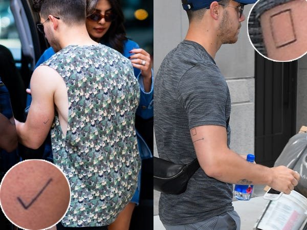 Nick Jonas showing the checkmark and box engagement tattoos