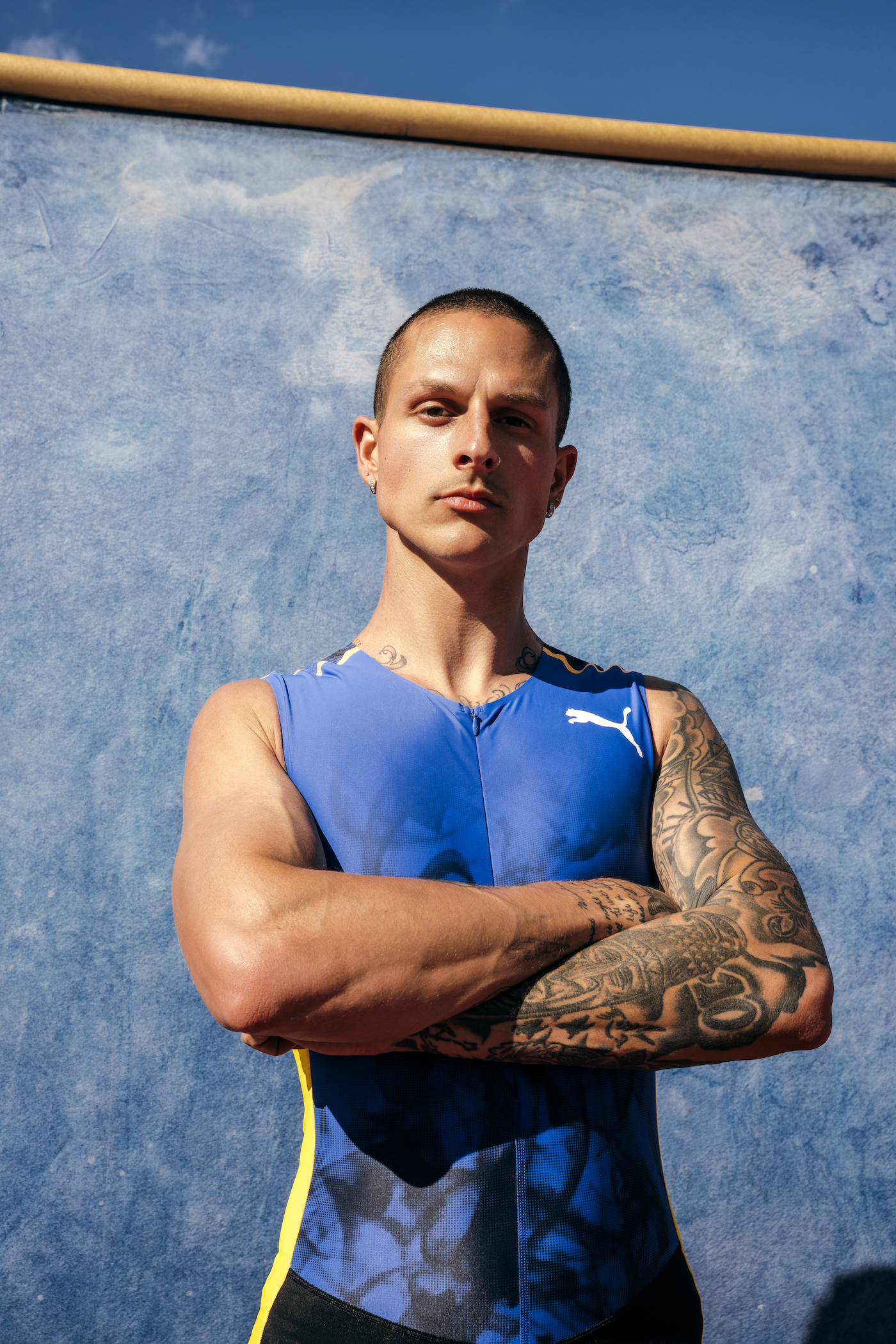 Nick Mayhugh shoulder and arm tattoos in a Puma portrait