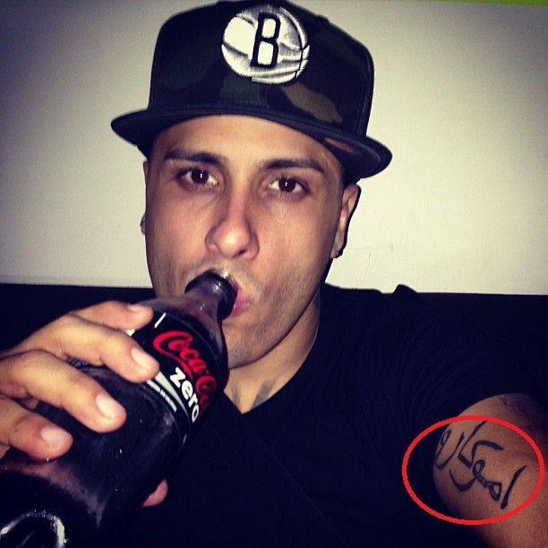 Nicky Jam Arabic upper arm tattoo