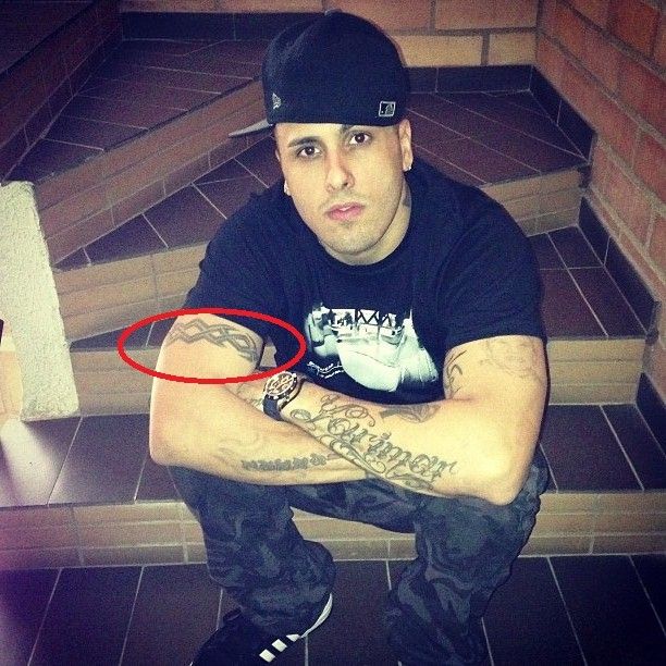 Nicky Jam astral band upper arm tattoo