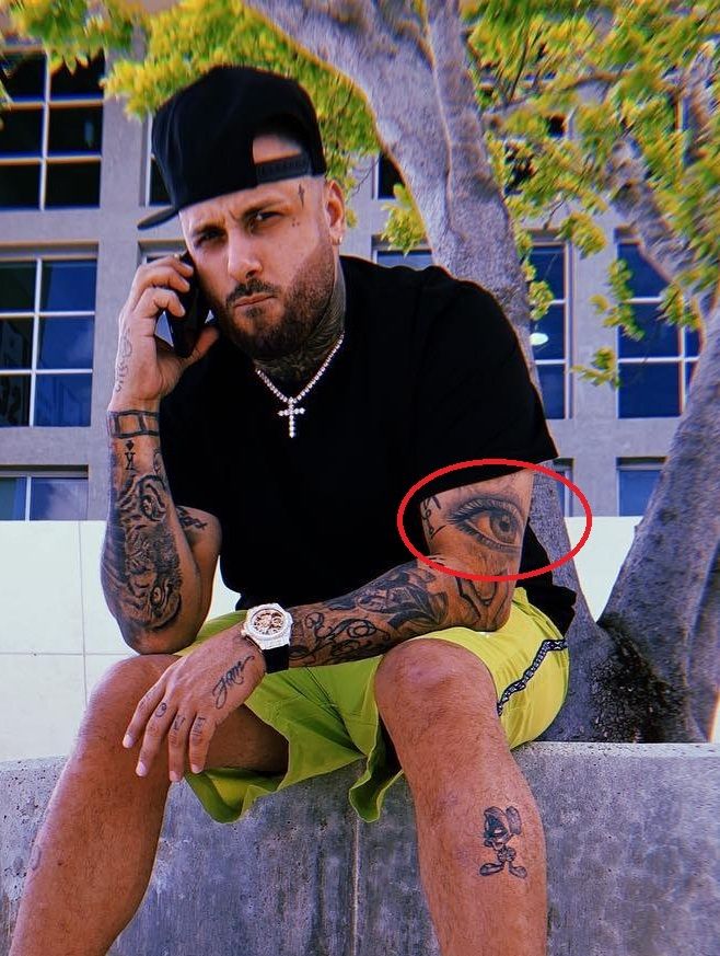 Nicky Jam eye elbow tattoo