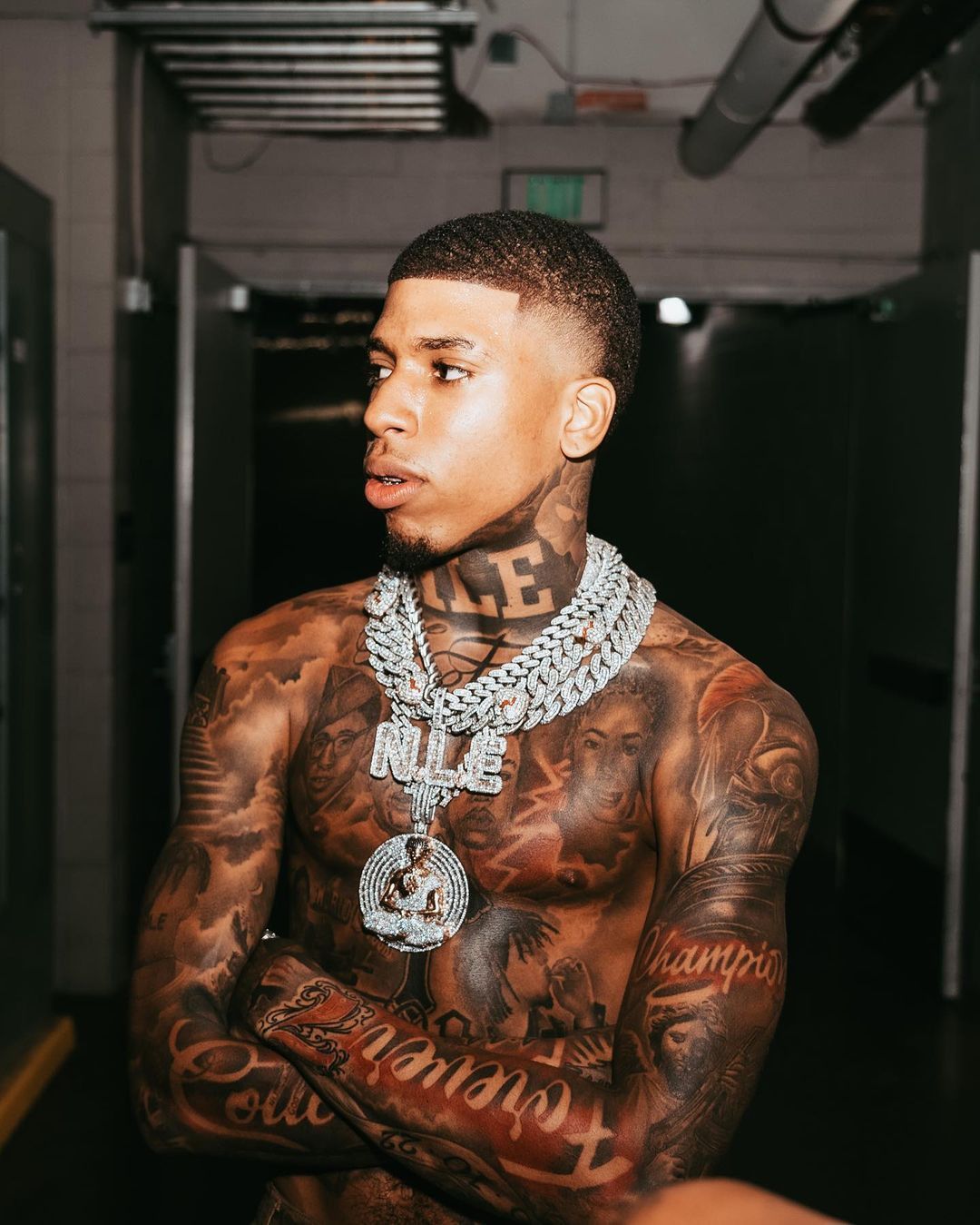 NLE Choppa crosses and memorial initials tattoos