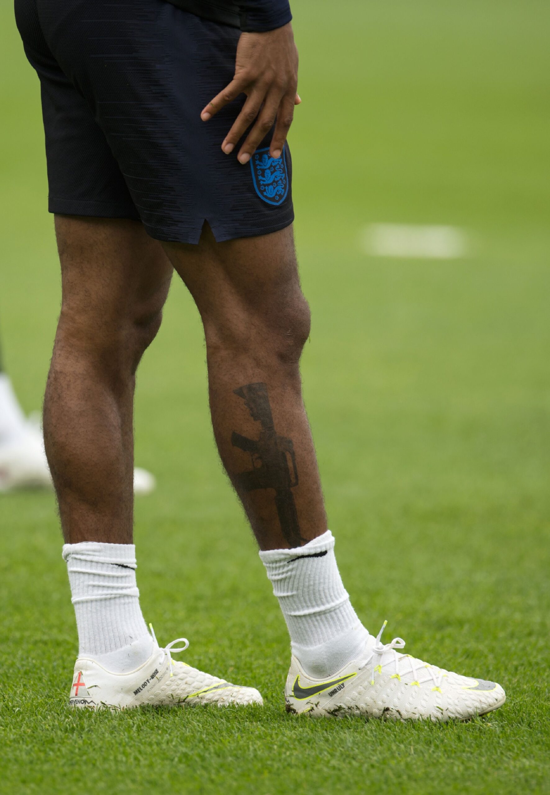 Raheem Sterling tattoos: very high-resolution training photograph showing the leg and surrounding football context