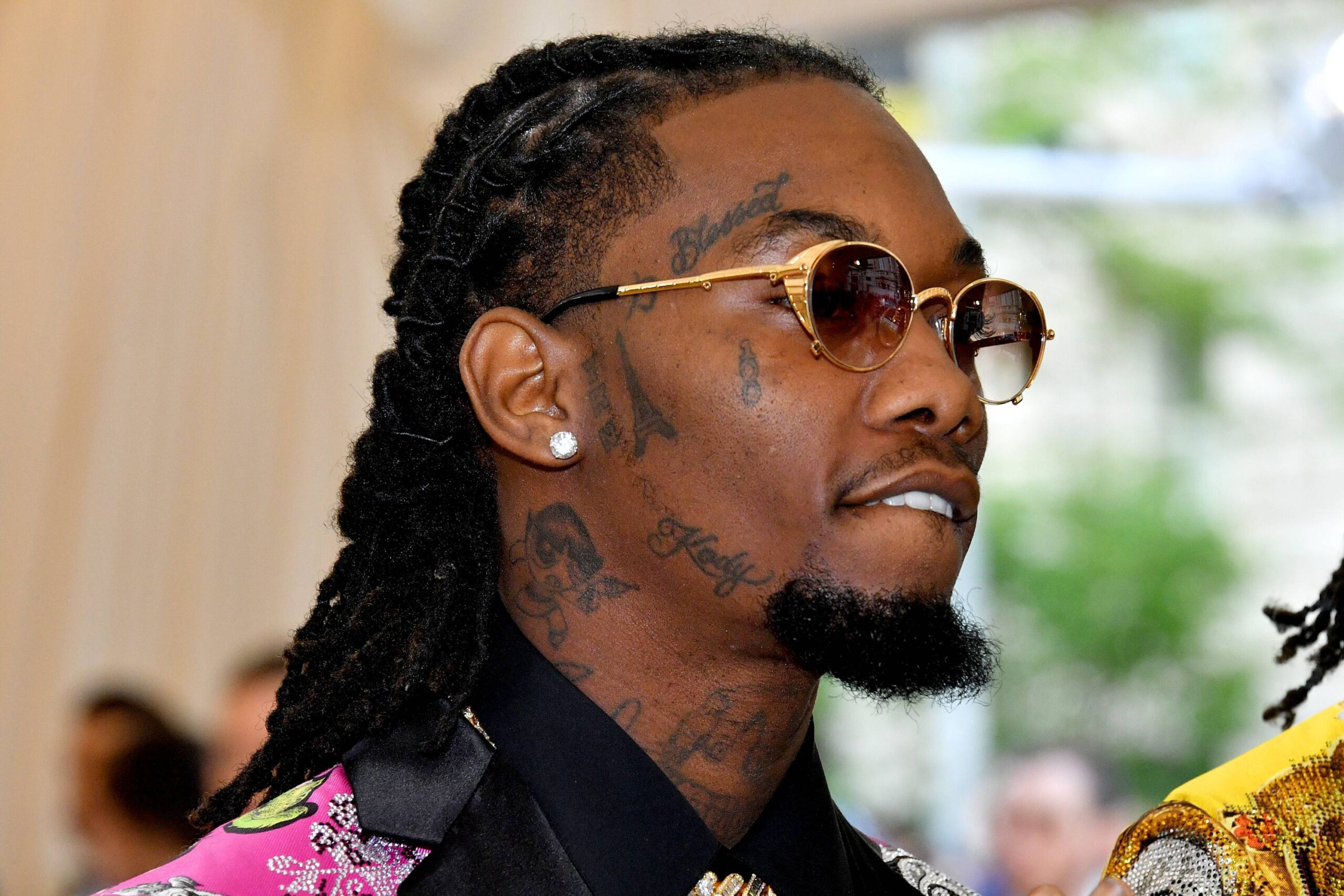 Offset’s visible face tattoos, including script and small designs along his cheek and brow.