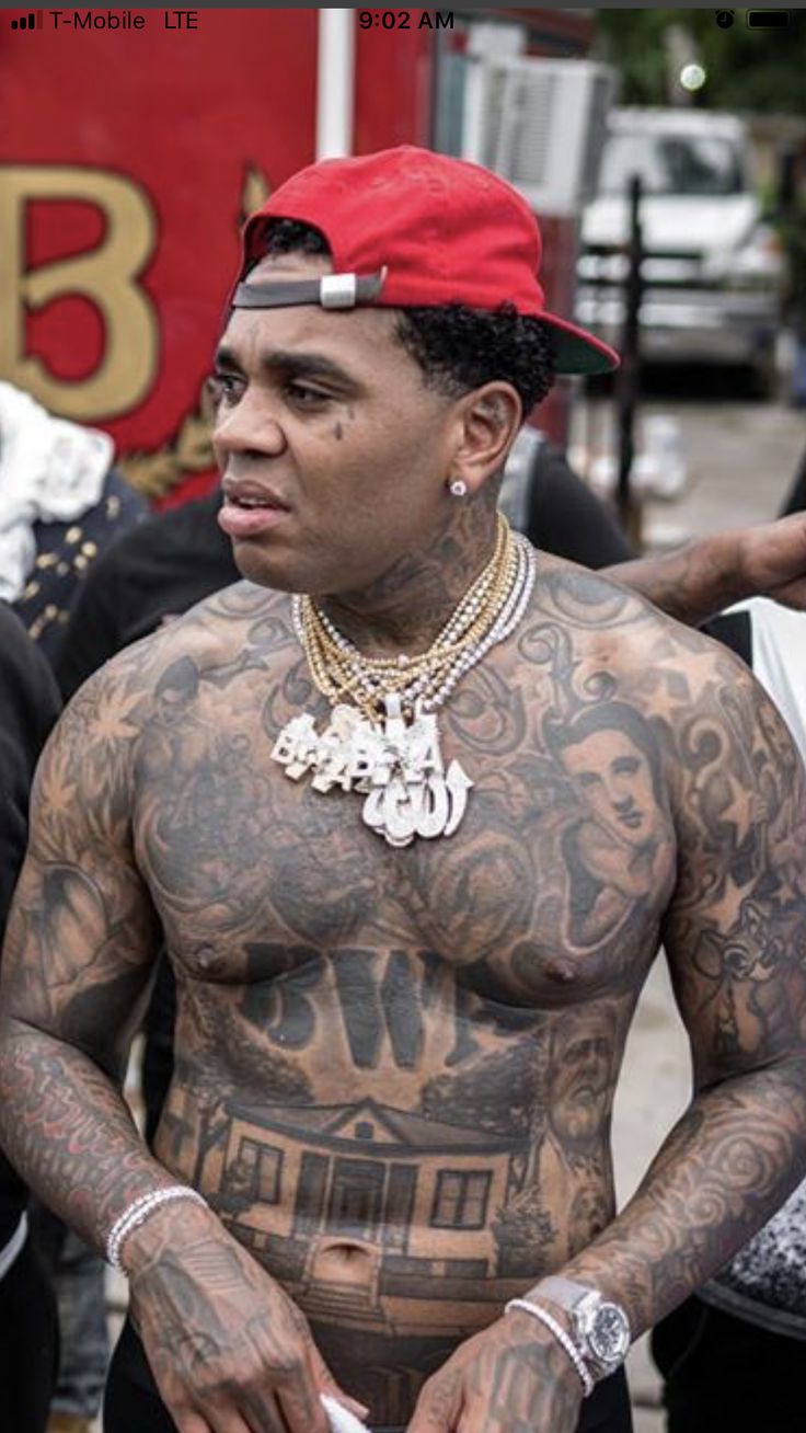 Kevin Gates chest lettering and torso tattoos