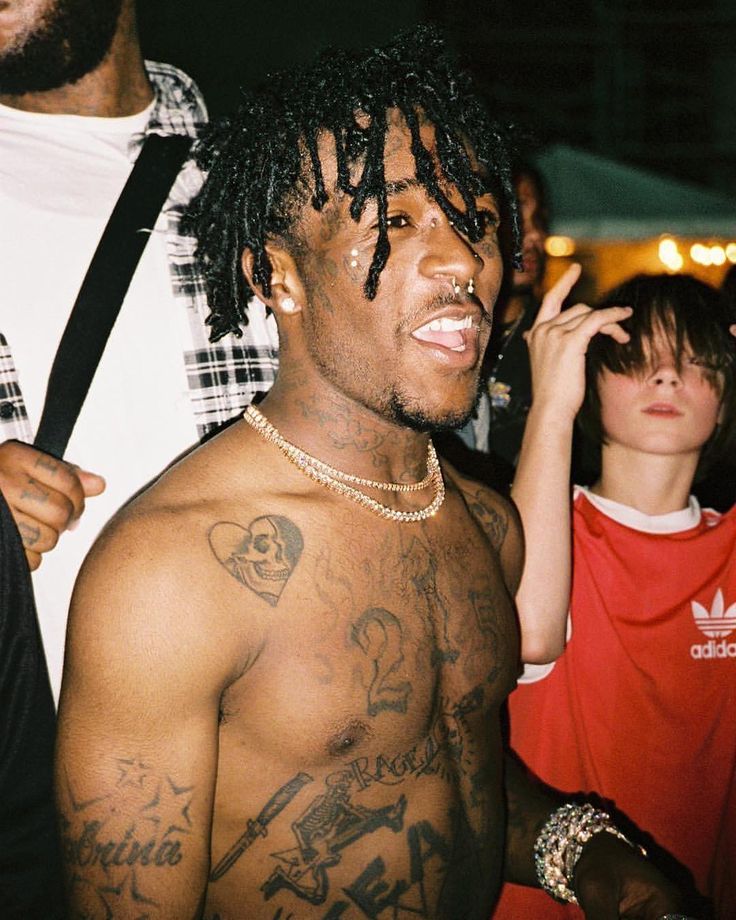 Lil Uzi Vert chest and shoulder tattoos at a party