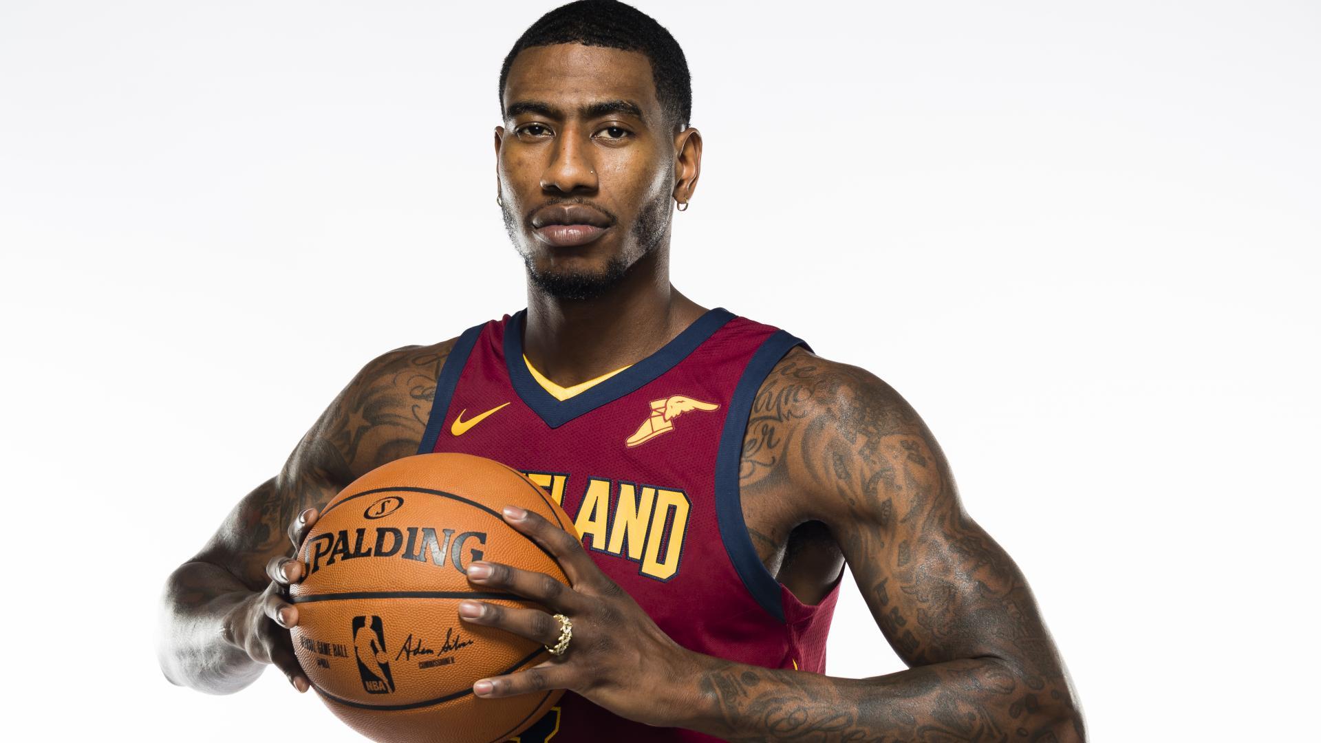 Iman Shumpert tattoos: large NBA photoshoot showing shoulder, upper-arm and forearm lettering