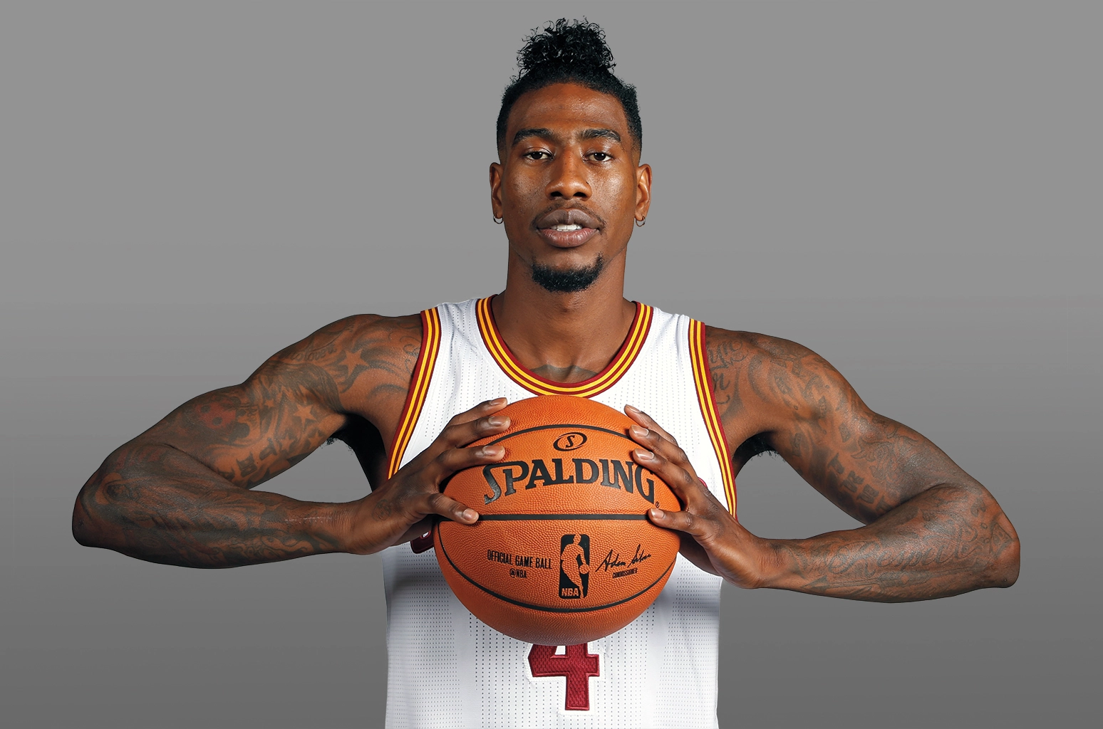 Iman Shumpert tattoos: wide basketball portrait showing both tattooed arms from shoulder to forearm