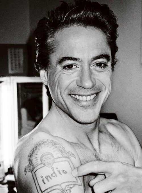 Robert Downey Jr. pointing to the Indio family tattoo on his shoulder