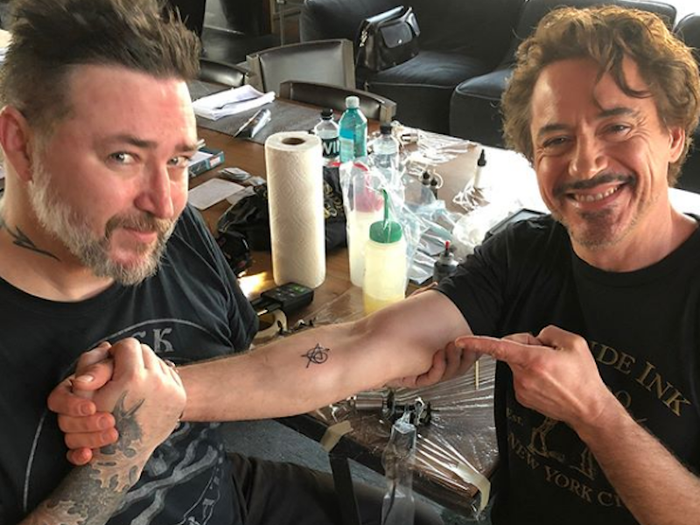 Robert Downey Jr. revealing his Avengers matching tattoo with tattoo artist Joshua Lord