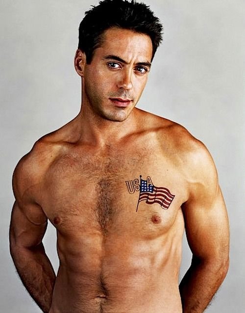 Robert Downey Jr. showing the USA and American flag tattoo on his chest