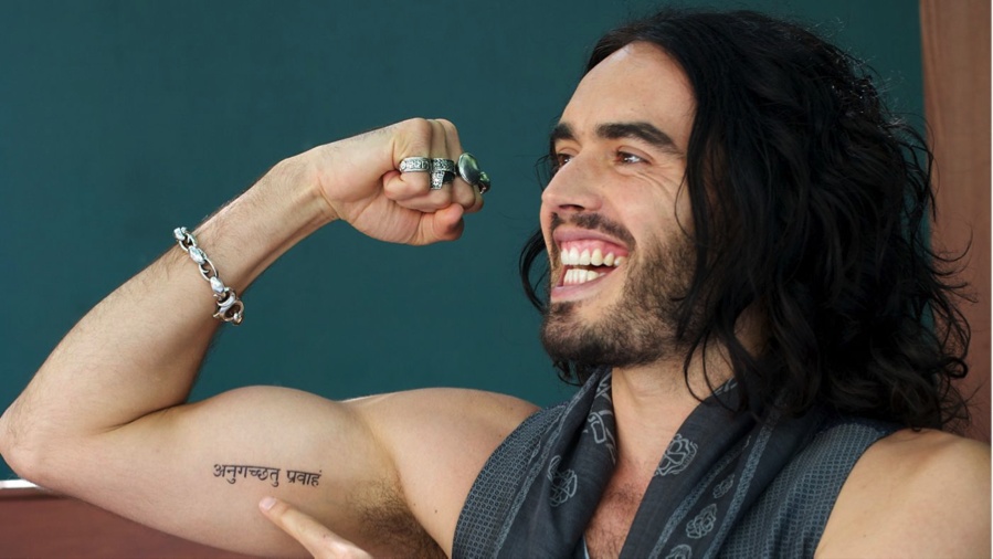 Russell Brand matching Sanskrit arm tattoo wider view
