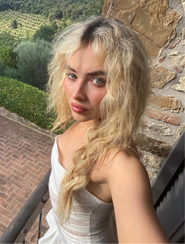 Sabrina Carpenter heart tattoo behind left ear