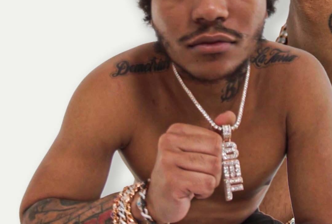 Lil Meech tattoos: Shoulder and upper-body lettering visible in the Tattoo Tour image