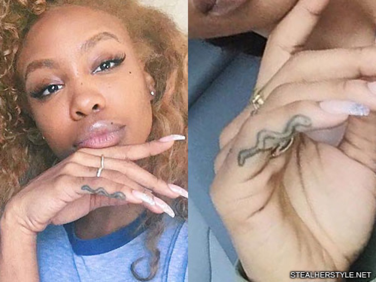 SZA tattoos: clear close-up of SZA’s snake finger tattoo