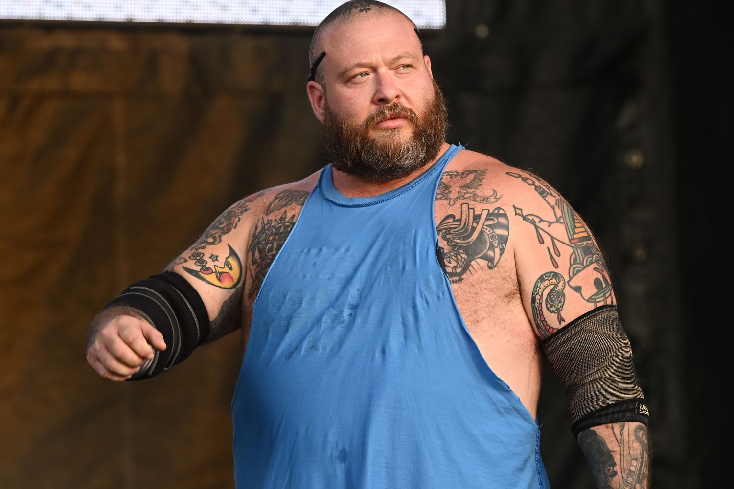 Action Bronson tattoos: castle and skull head tattoos