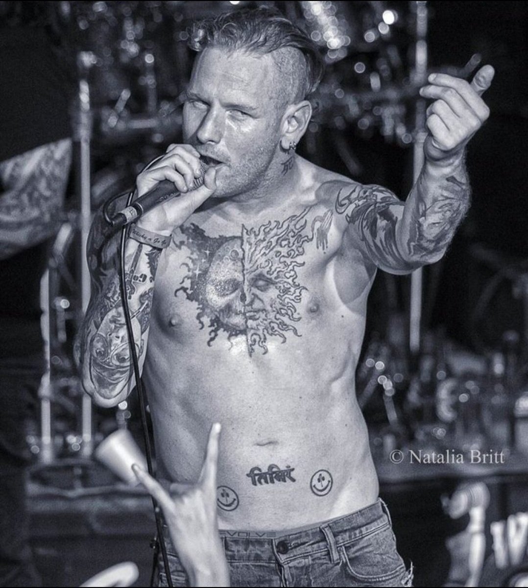 Corey Taylor tattoos: sun-and-moon chest tattoo and lower-abdomen lettering