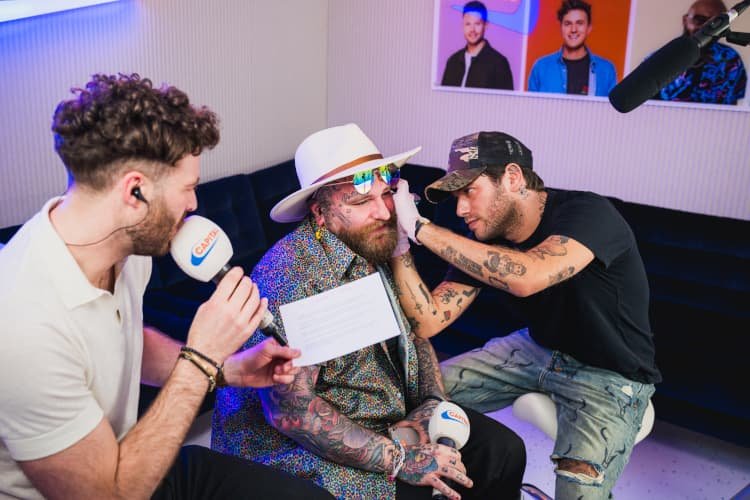 Teddy Swims during a tattoo session showing visible arm and facial work
