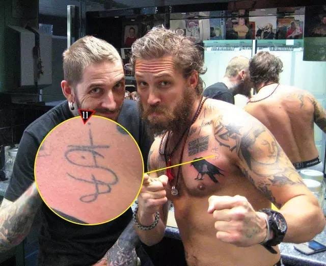 Tom Hardy showing his wider torso tattoo collection