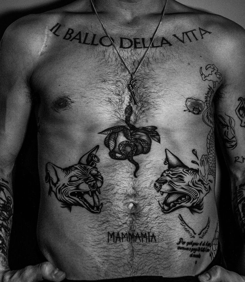 Damiano David tattoos: Torso lettering, snake, MAMMAMIA and surrounding designs