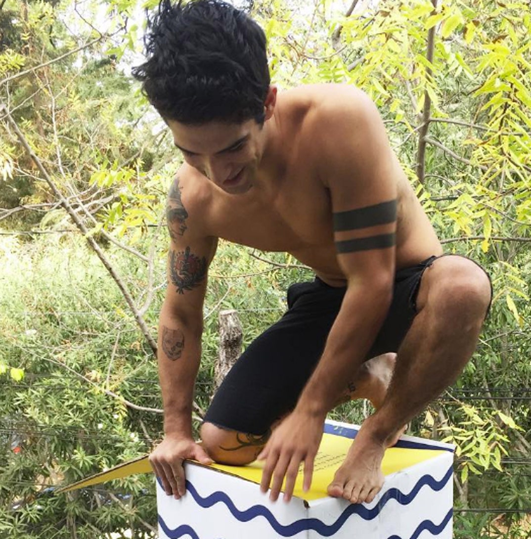 Tyler Posey colorful arm tattoos outdoors