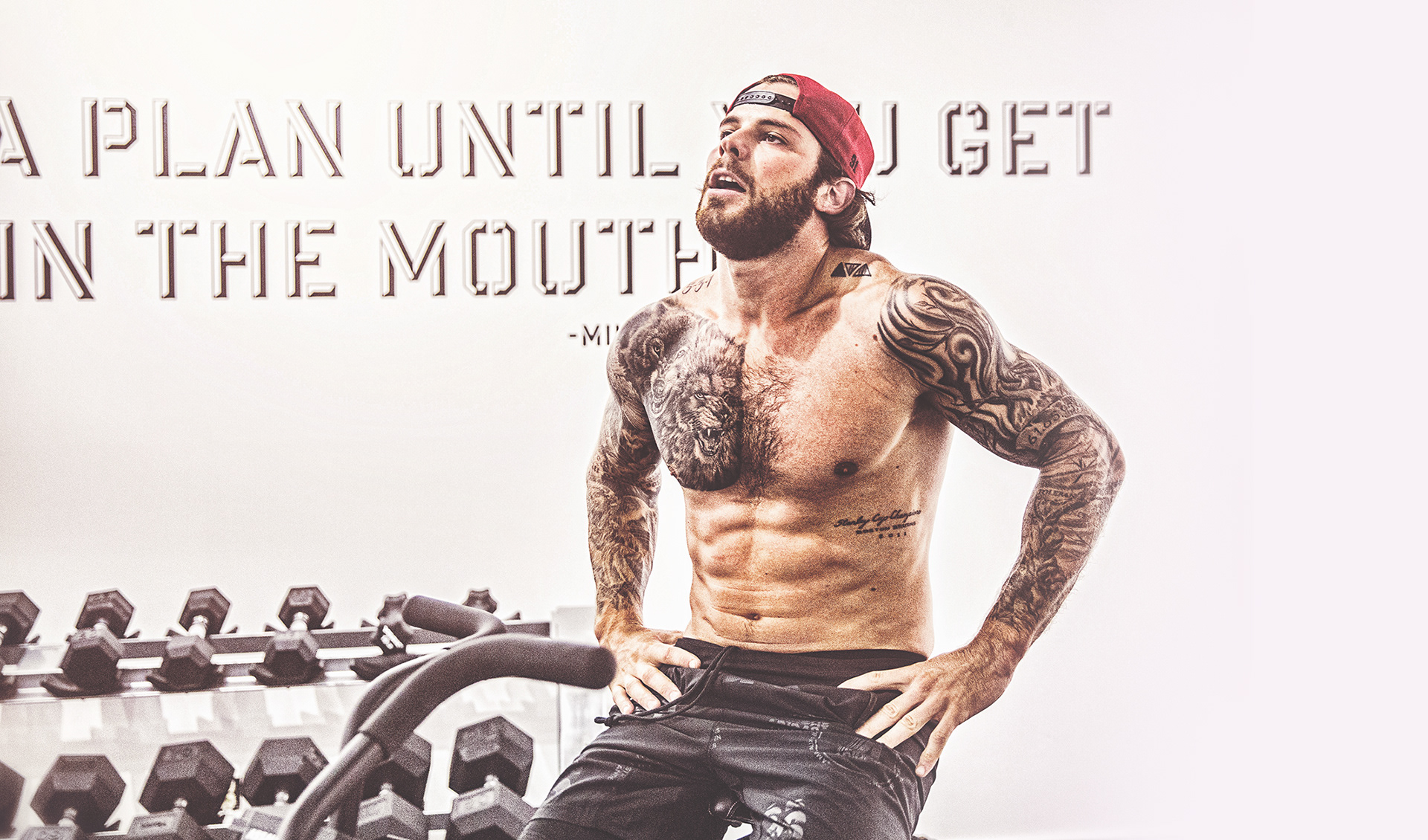 Tyler Seguin wolf and lion chest tattoos in a gym portrait