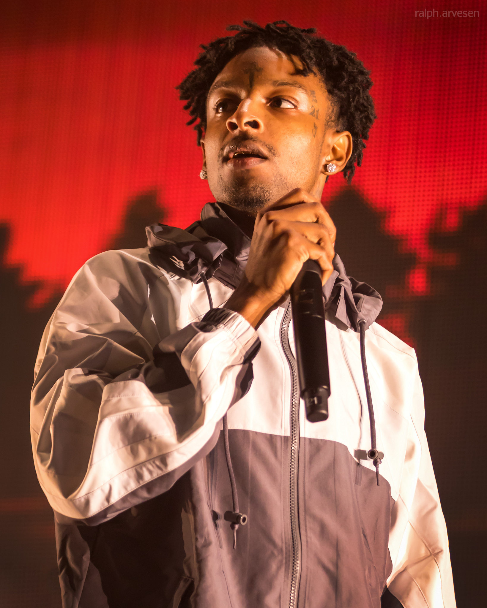 21 Savage performing with visible arm and face tattoos